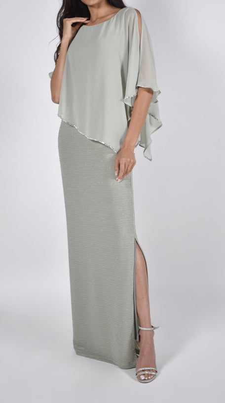 Woman wearing a light green dress with a slit on the side.